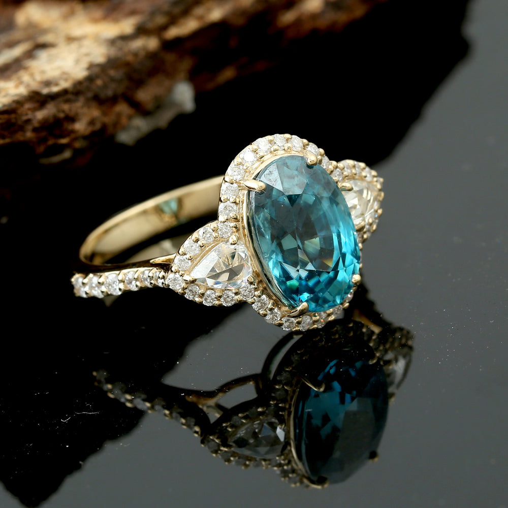 Oval Blue Zirconia & Pear Diamond Halo Ring in 18K Yellow Gold